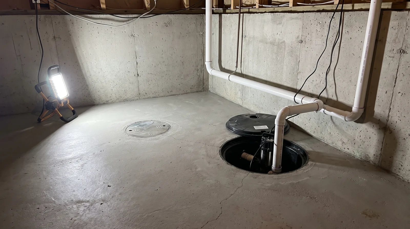 Basement water management with sump and backwater valve in a Hamilton home
